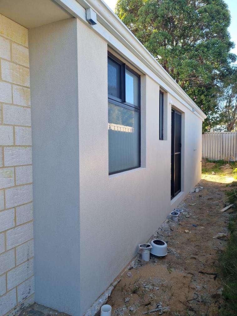 Renovated weatherboard cottage with verandah under a clear blue sky