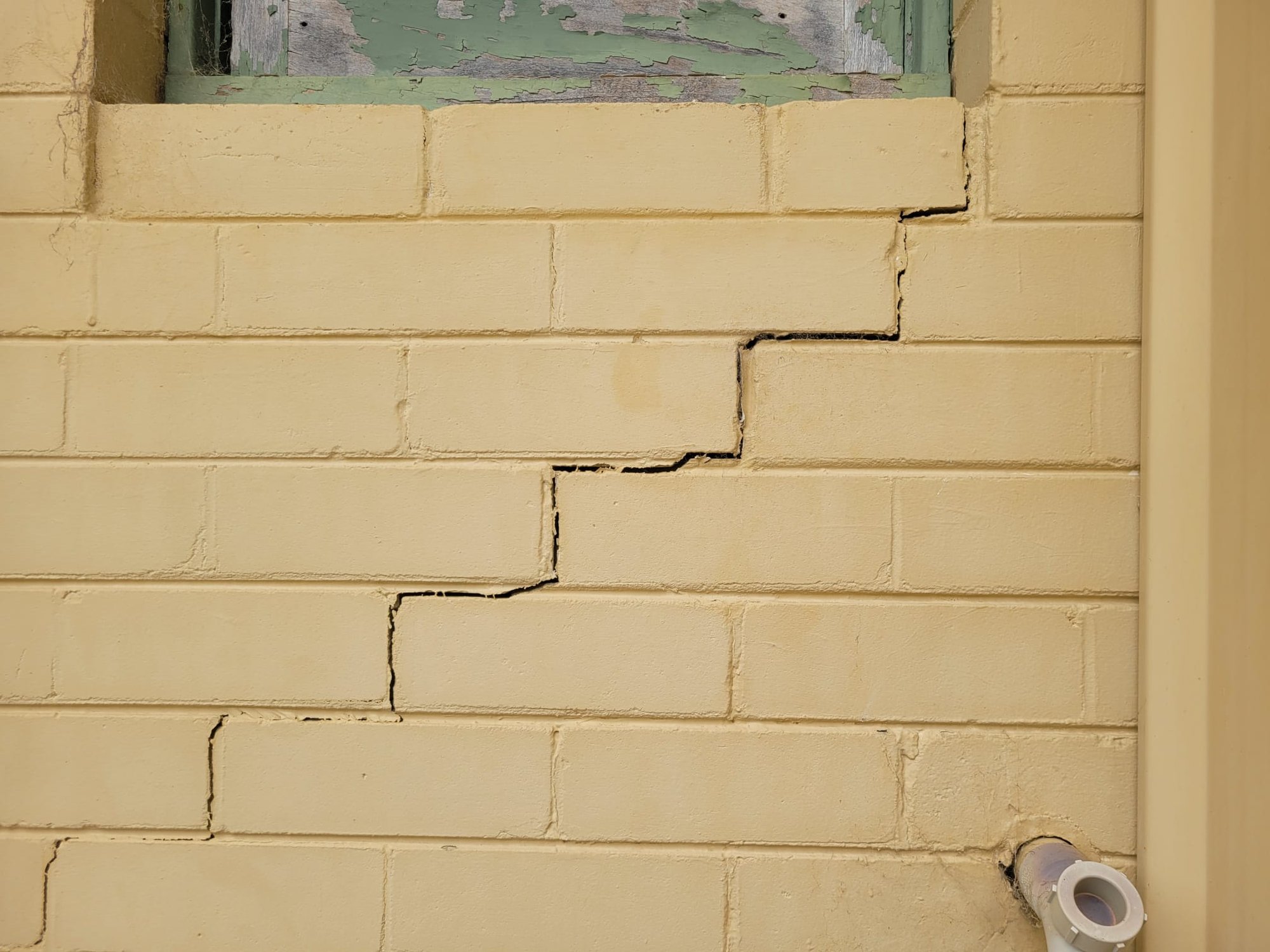 Diagonal crack radiating from an interior window corner