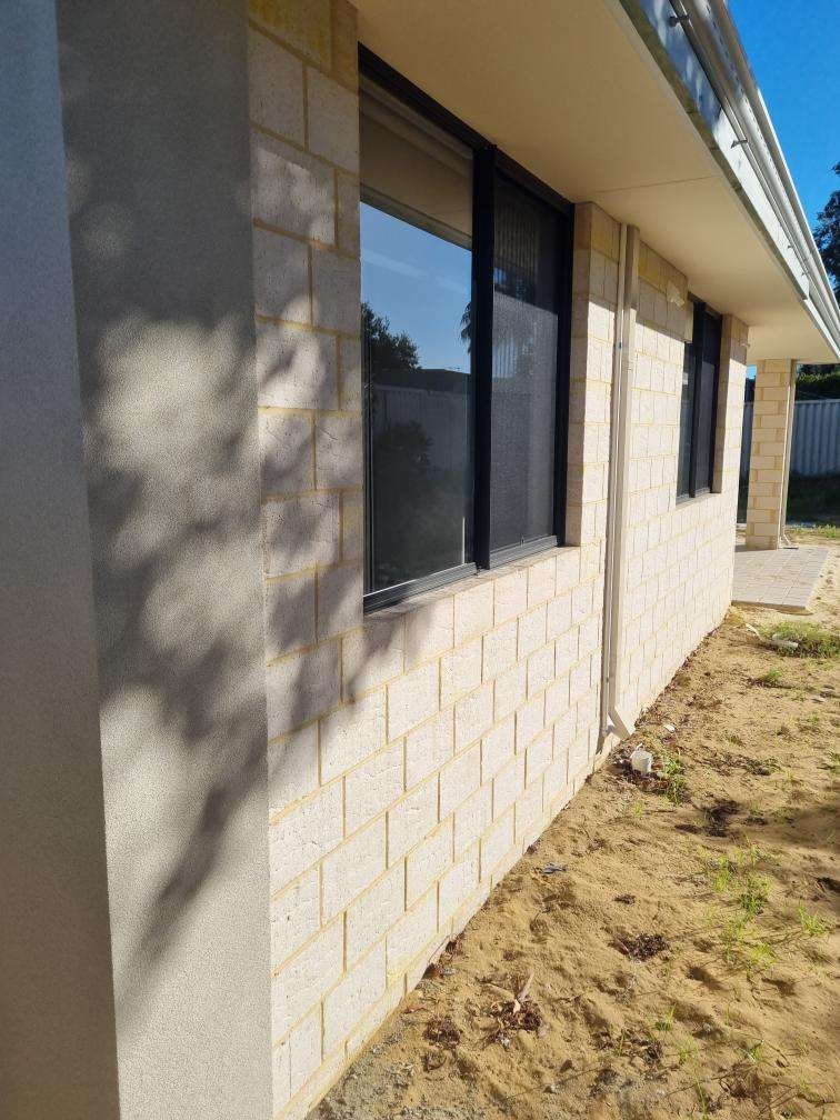 Limestone block home exterior with aluminium-framed windows