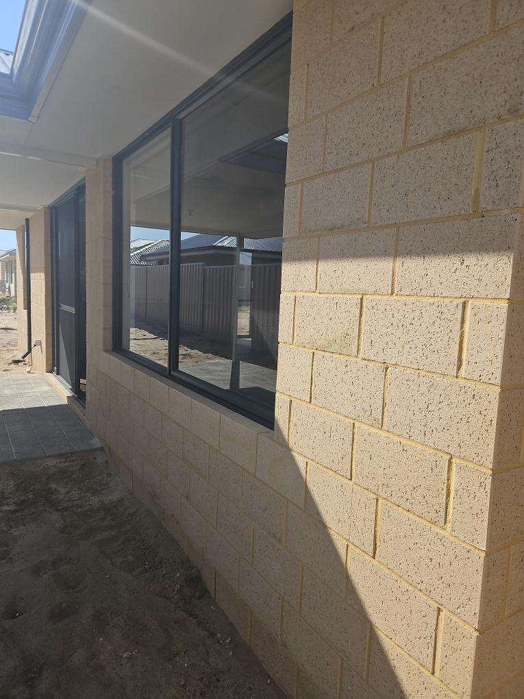 Exterior Walls Require Acid Clean — real finishes defect photographed in a SURE Building Inspections report