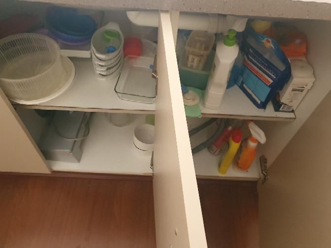 Water Damage to Cabinet and Kickboard — real finishes defect photographed in a SURE Building Inspections report
