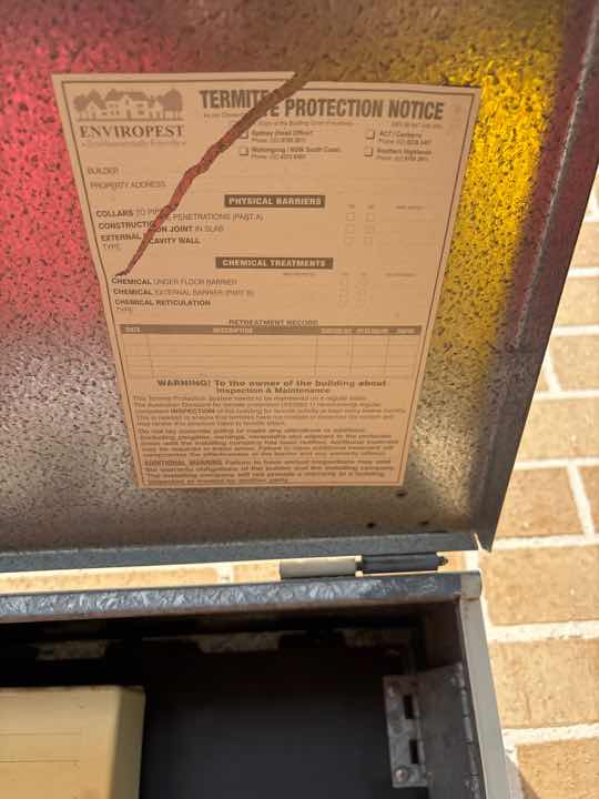 Evidence of Previous Termite Treatment (Drill Holes) — real termite defect photographed in a SURE Building Inspections report