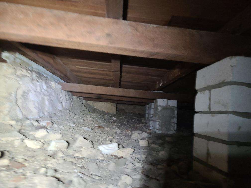 Debris in Subfloor — real compliance defect photographed in a SURE Building Inspections report