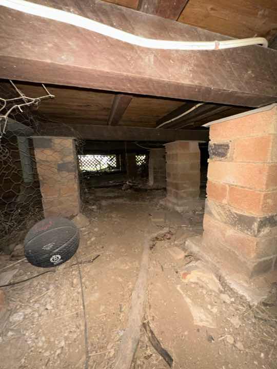 Sub-Floor Soil Dampness — real moisture defect photographed in a SURE Building Inspections report