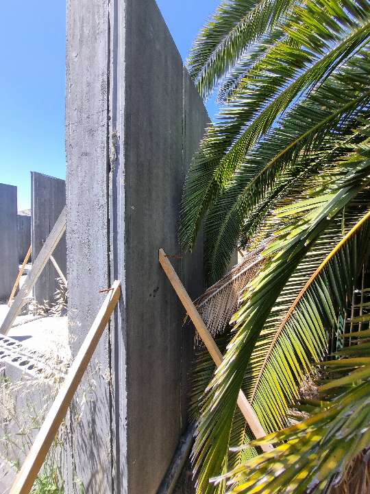 External Wall Panel Protruding from Plumb Line — real structural defect photographed in a SURE Building Inspections report