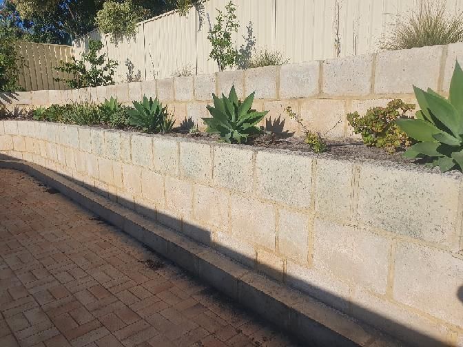 Leaning retaining wall — real structural defect photographed in a SURE Building Inspections report