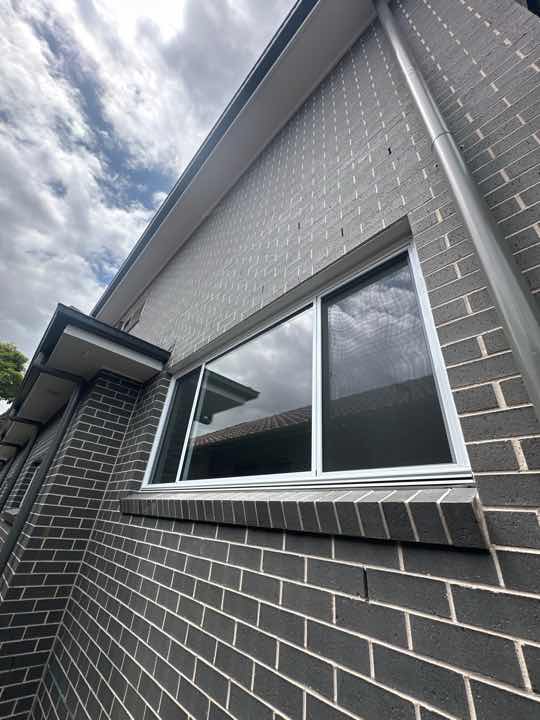 Gaps between Window Frame and Wall Cladding — real moisture defect photographed in a SURE Building Inspections report
