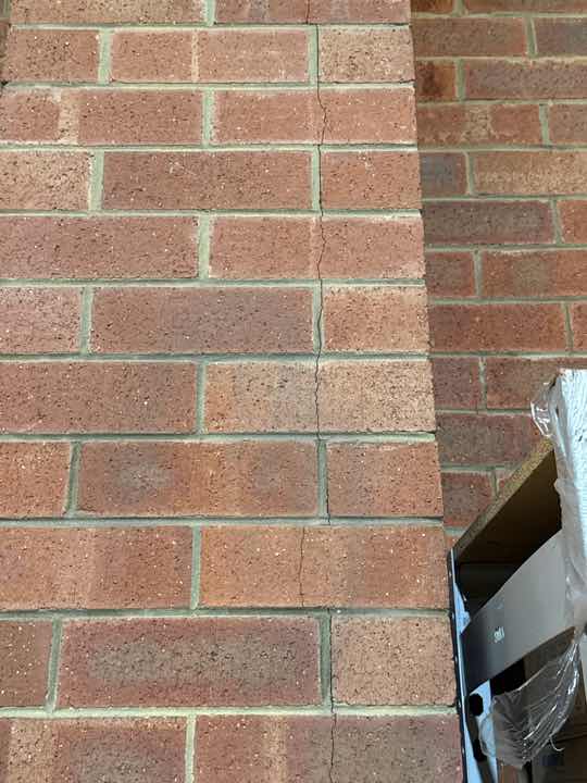 Warehouse Area Termite Damage to Skirting/Wall — real termite defect photographed in a SURE Building Inspections report