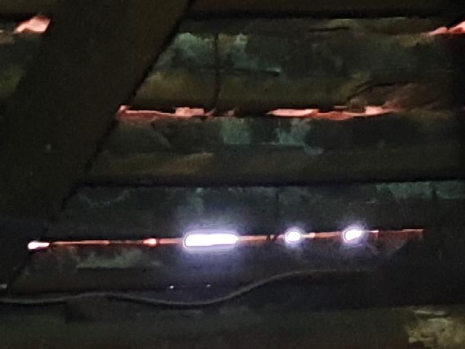 Hazardous Electrical Works near Roof Insulation — real electrical defect photographed in a SURE Building Inspections report