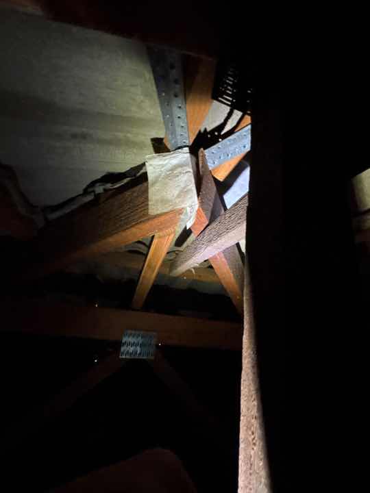 Restricted Roof Void Access Due to Obstructions — real termite defect photographed in a SURE Building Inspections report