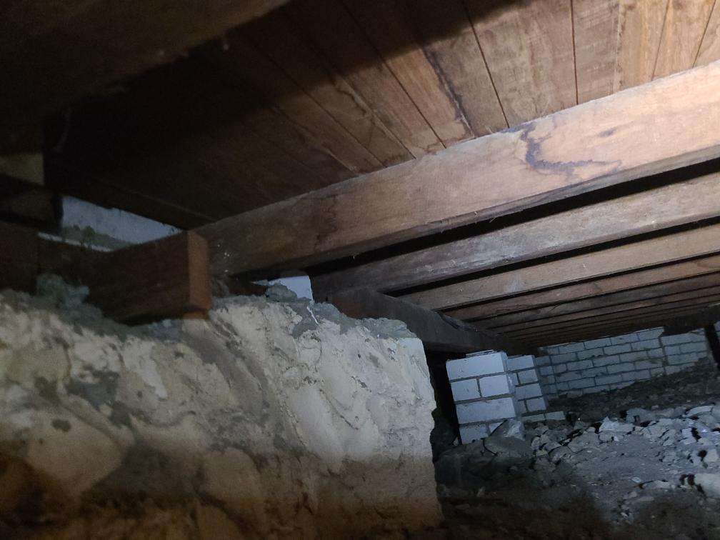 Debris in Subfloor — real compliance defect photographed in a SURE Building Inspections report
