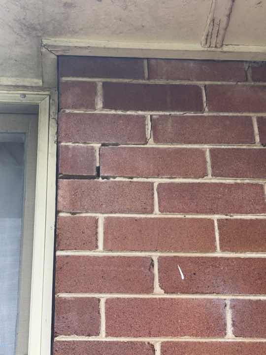 Repointed Masonry Wall Cracks — real structural defect photographed in a SURE Building Inspections report