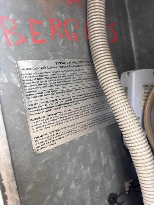 Illegible Termite Treatment Notice — real termite defect photographed in a SURE Building Inspections report