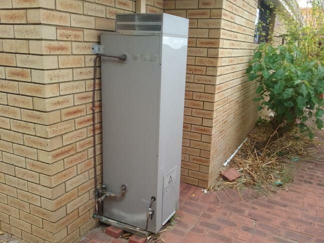 Damp on Exterior Wall from Gutter Leak — real moisture defect photographed in a SURE Building Inspections report