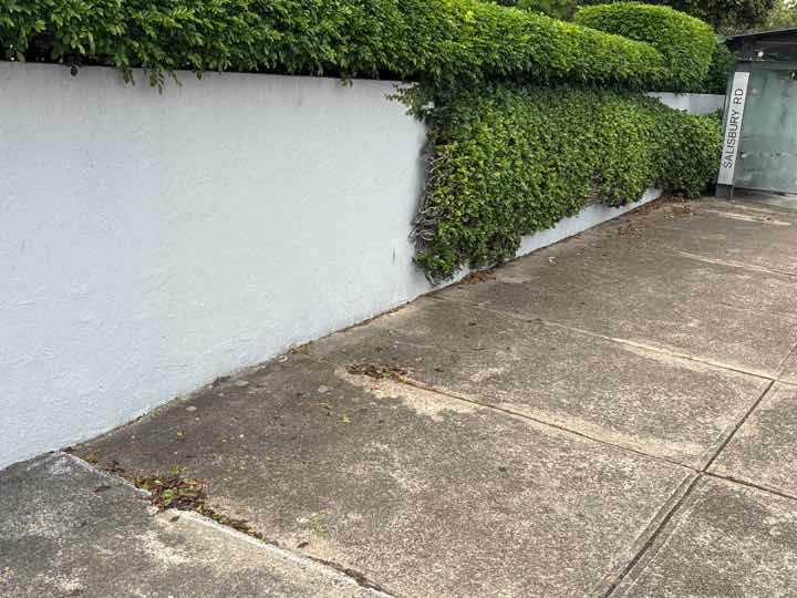 Leaning retaining wall — real structural defect photographed in a SURE Building Inspections report