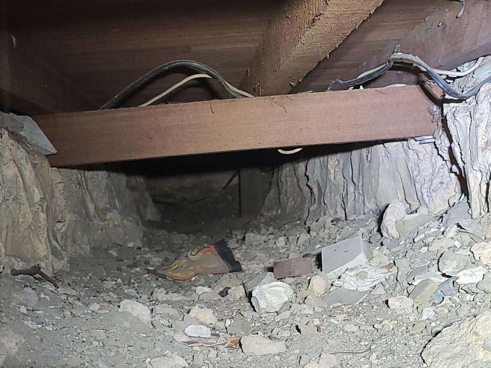 Debris in Subfloor — real compliance defect photographed in a SURE Building Inspections report