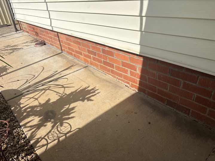 Mulch and Garden Beds Against Building Termite Conducive — real termite defect photographed in a SURE Building Inspections report
