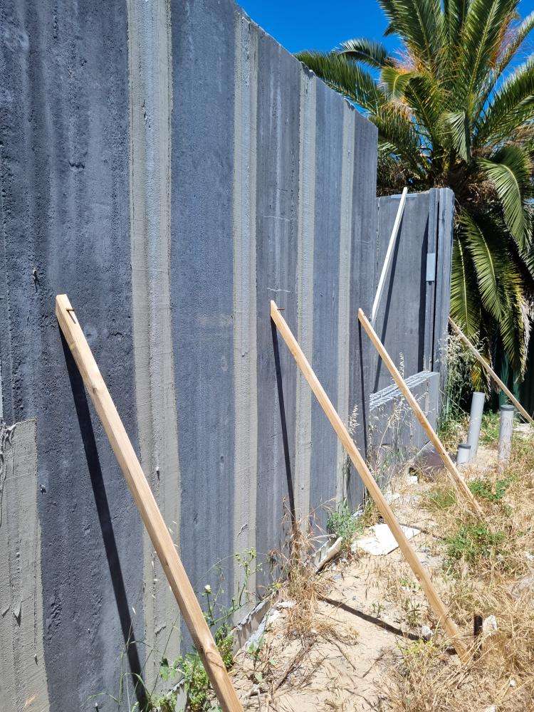 External Wall Panel Protruding from Plumb Line — real structural defect photographed in a SURE Building Inspections report