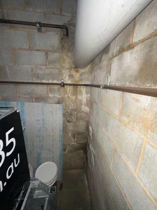Basement Floor Slab Settlement Cracking — real structural defect photographed in a SURE Building Inspections report