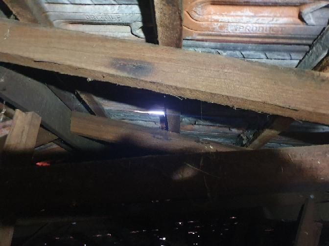 Hazardous Electrical Works near Roof Insulation — real electrical defect photographed in a SURE Building Inspections report