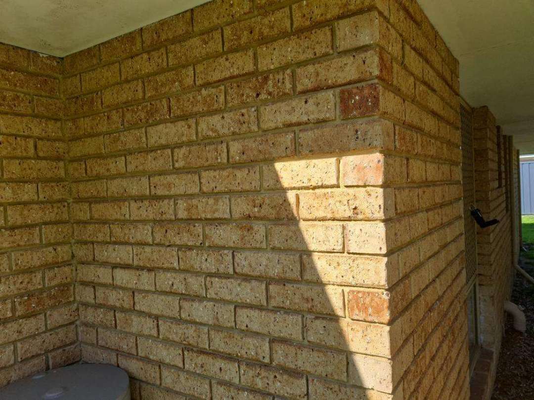Eroded Mortar in Exterior Brickwork — real finishes defect photographed in a SURE Building Inspections report