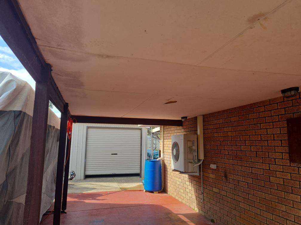 Weathered And Cracked Carport Posts — real structural defect photographed in a SURE Building Inspections report
