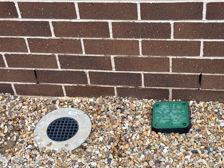 Partially Covered Weep Holes — real moisture defect photographed in a SURE Building Inspections report