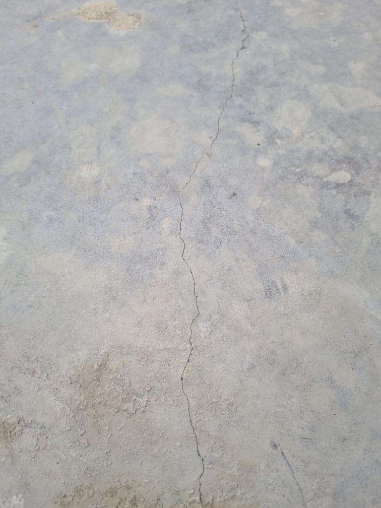 Minor Surface Slab Cracks — real structural defect photographed in a SURE Building Inspections report