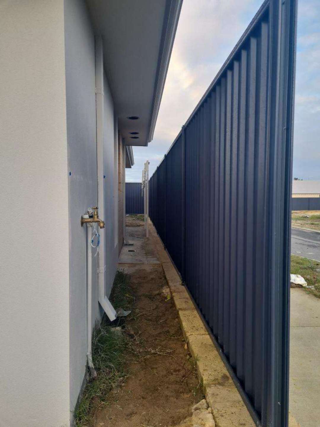 Unpainted Exterior Pipes — real finishes defect photographed in a SURE Building Inspections report