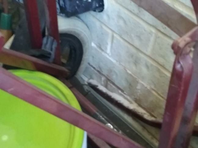 Obstructed Structural Inspection — real structural defect photographed in a SURE Building Inspections report