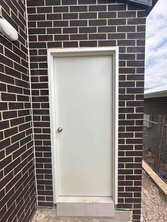 Gaps Around Laundry Door Frame — real moisture defect photographed in a SURE Building Inspections report